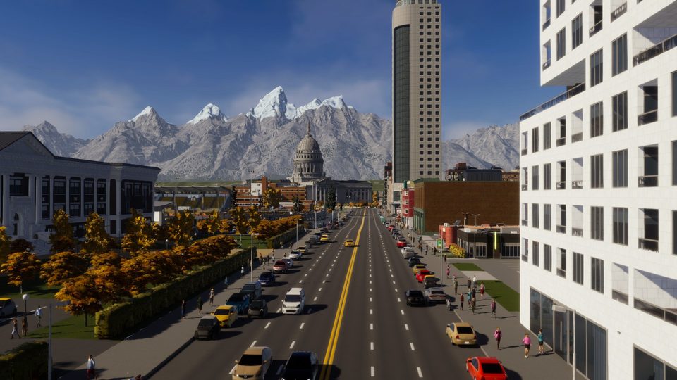 Downtown street by daylight with the capitol dome and a high-rise in view